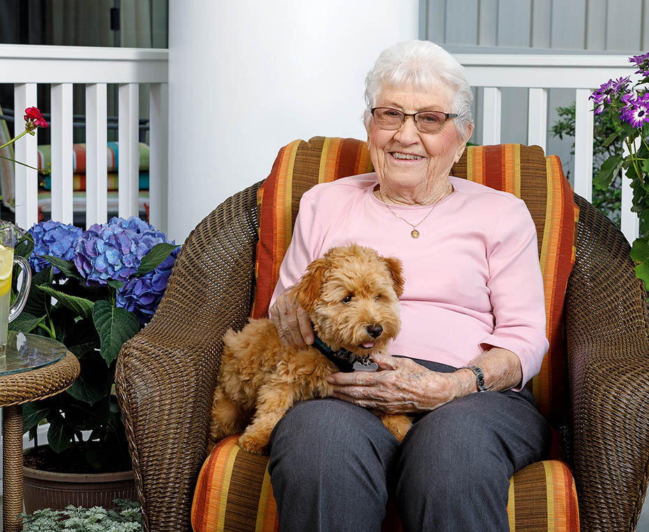happy female resident with visiting dog